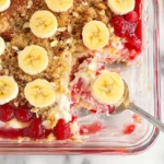 this banana split dump cake has strawberries and bananas on top