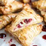 croissants filled with jelly and cream on a baking sheet, ready to be eaten