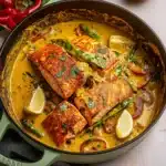 two pictures of fish in coconut curry with limes on top and the same image above