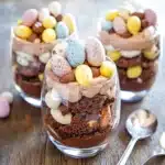 three desserts in small glass dishes on a table