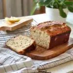 sliced banana bread on a cutting board with text overlay that reads the best banana bread