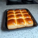 a loaf of bread sitting on top of a white plate next to another loaf of bread