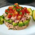 avocado and tomato salad with a fork stuck