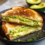 the grilled cheese sandwich is loaded with creamy avocado and cheesy