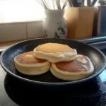 pancakes are stacked on top of each other with blueberries and syrup