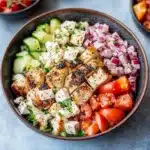chicken and greek salad in a bowl with the words gluten - free healthy easy yummy greek chicken bowl