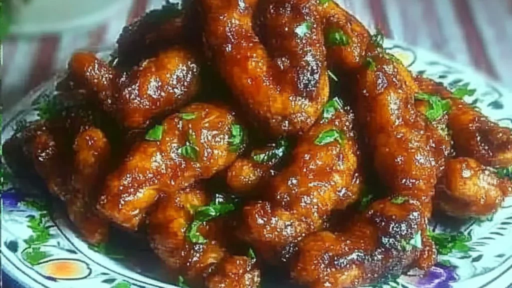 the cover of dragon chicken on a white plate with chopsticks and green onions