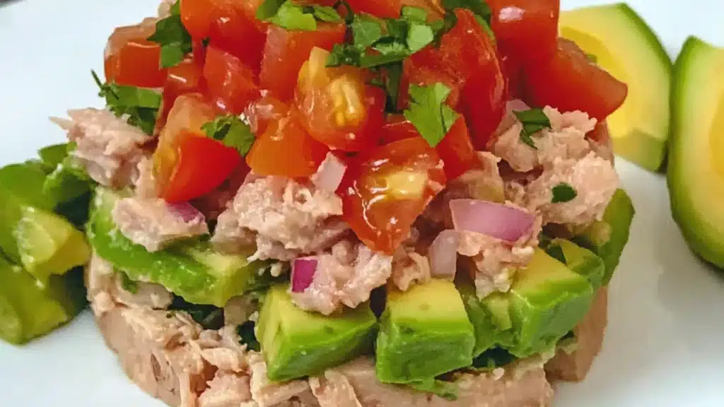 avocado and tomato salad with a fork stuck