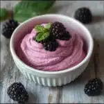 blackberry mousse in a bowl with blackberries on top and the words blackberry mousse above it